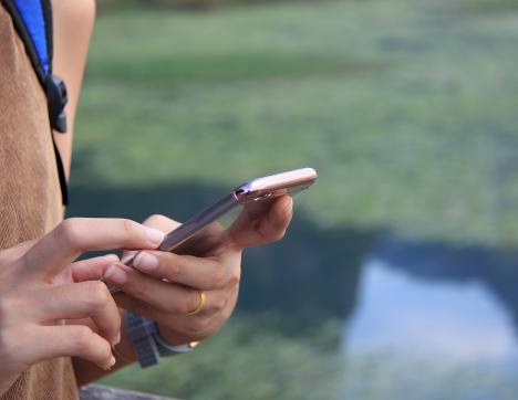 a person walking holding a phone