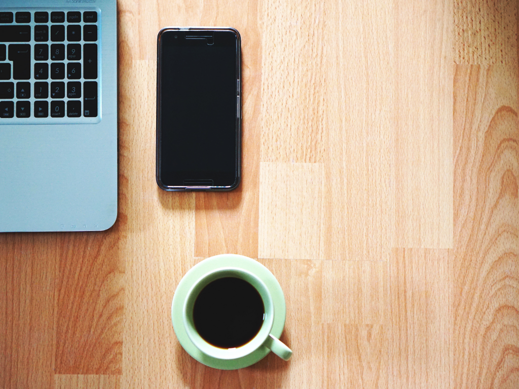 Phone and coffee on a desk